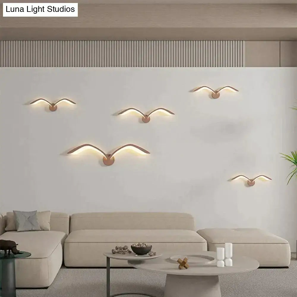 Five modern copper-toned seagull wall lamp sconces with warm led lighting in nordic avian style indoor decor