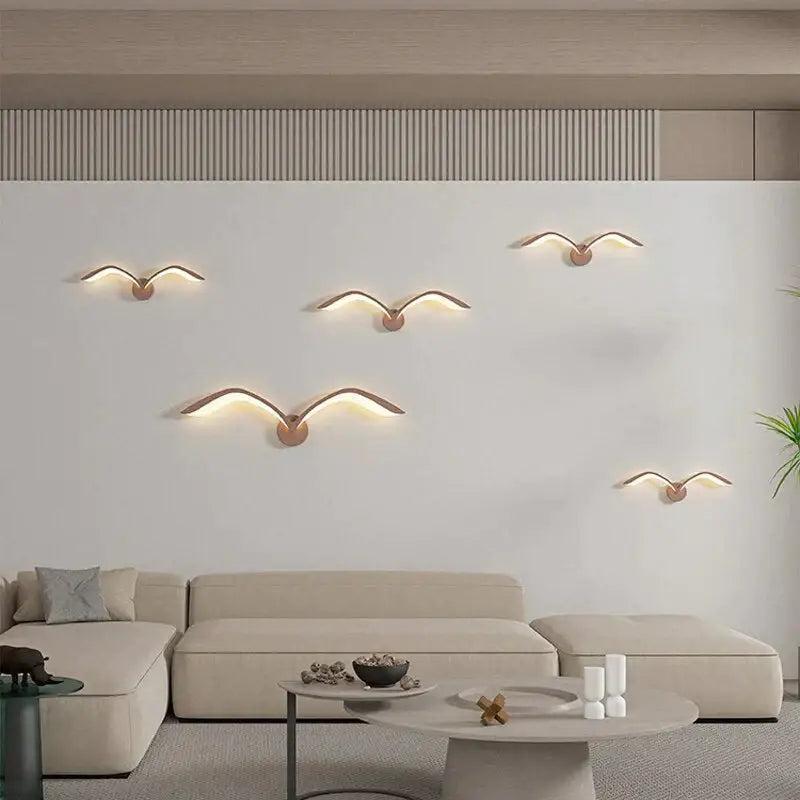 Modern white nordic avian style wall lamp featuring five warm metallic seagull sconces with glowing led wings for indoor use