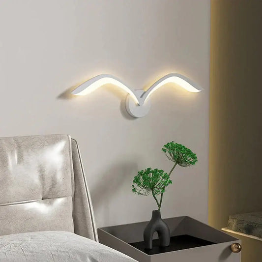 White modern nordic avian style wall lamp with sleek curved wing design for indoor bedroom use