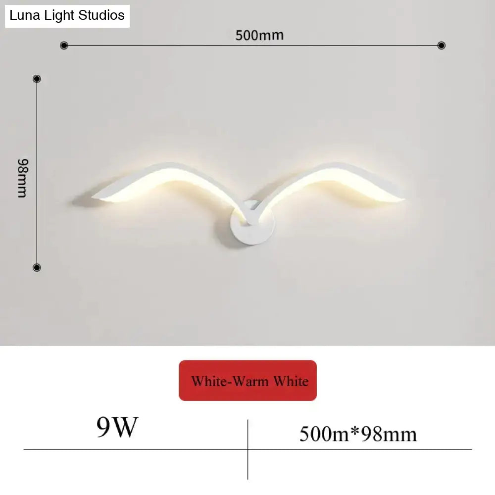 Modern white nordic avian style wall lamp shaped like a seagull with warm white lighting for indoor use