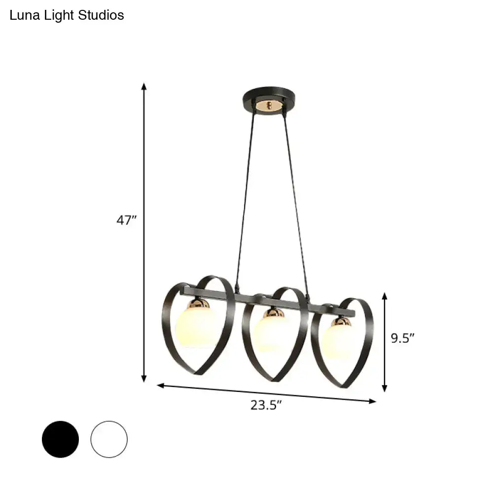 Black metal chandelier with three heart-shaped frames and frosted opal glass globe shades in white black 110v-120v bulb base