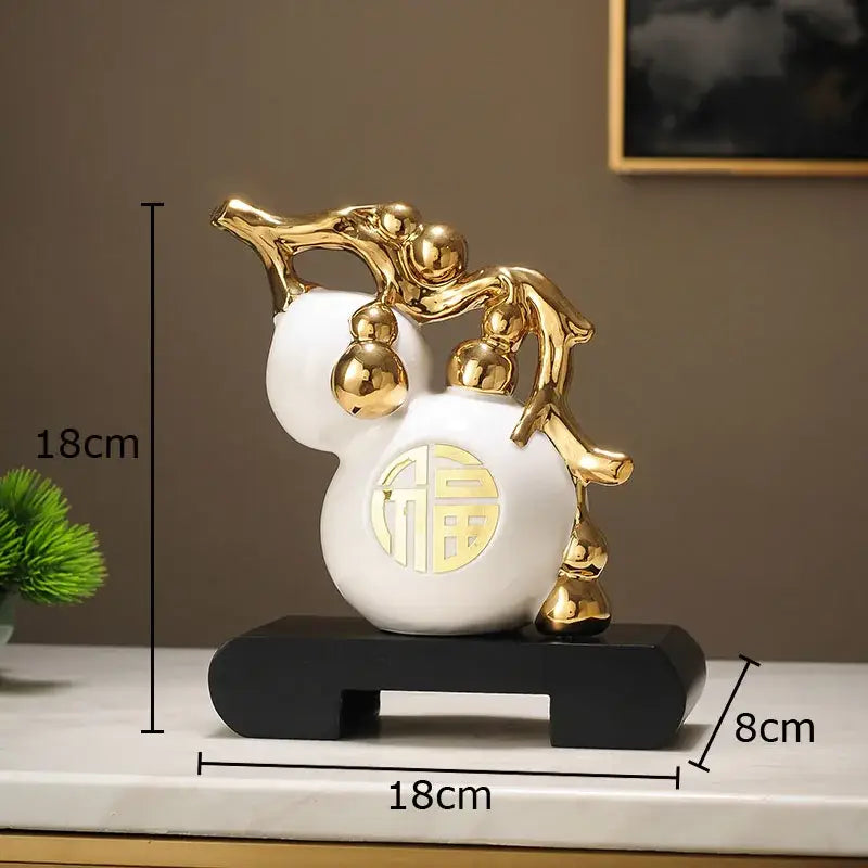 Modern white and orange golden gourd ceramic sculpture with gold metallic accents on black base for living room decorbites golden gourd