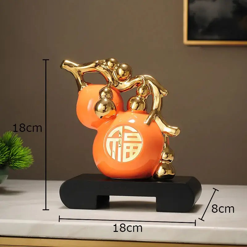 Modern white and orange golden gourd ceramic sculpture with gold metallic accents and circular 福 character decorbites golden gourd