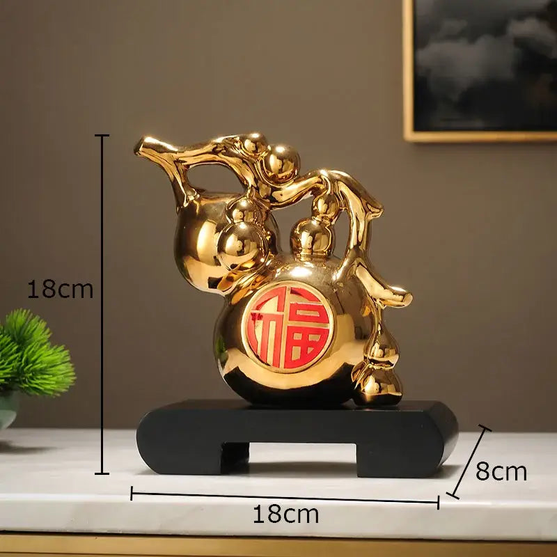 Modern white and orange golden gourd ceramic sculpture with red emblem on black base decorbites golden gourd decor