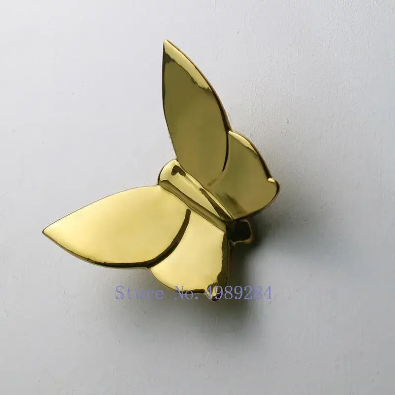 Gold-colored butterfly wall mount metal pin with smooth reflective surfaces for modern decorbites butterfly wall decorbites butterfly wall mount