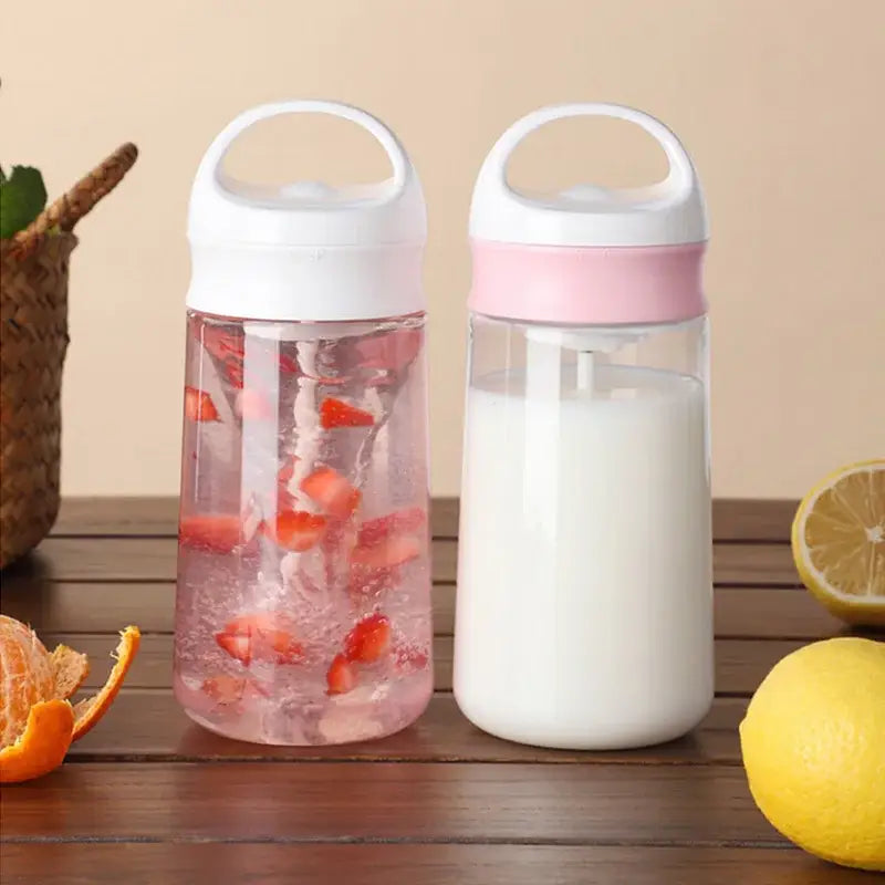 Modern white and pink electric protein shaker bottle with transparent plastic and two lids filled with infused water and milk