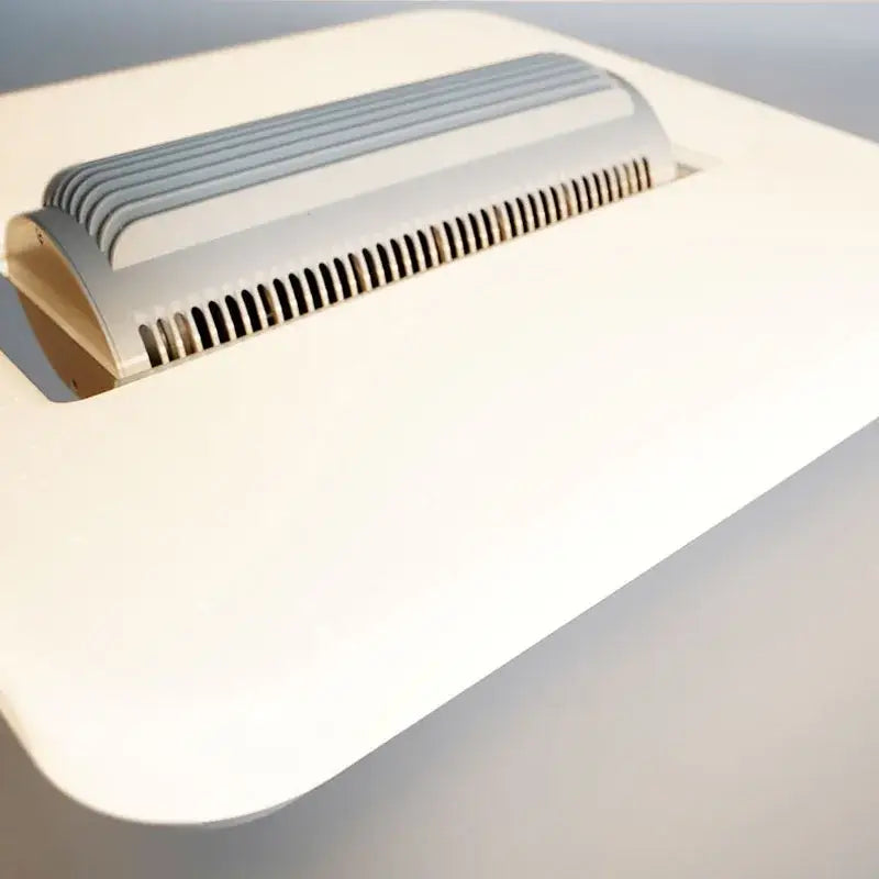 White rectangular desk lamp with silver ribbed top and ventilation slits in modern ceiling fan light design
