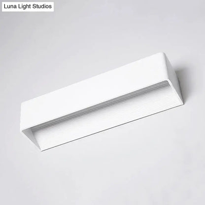 Minimalist modern white rectangular wall lamp with warm white light for bedroom featuring sleek black white design