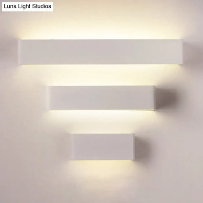 Modern white rectangular wall lamp with sleek minimalist design and warm white ambient lighting for bedrooms