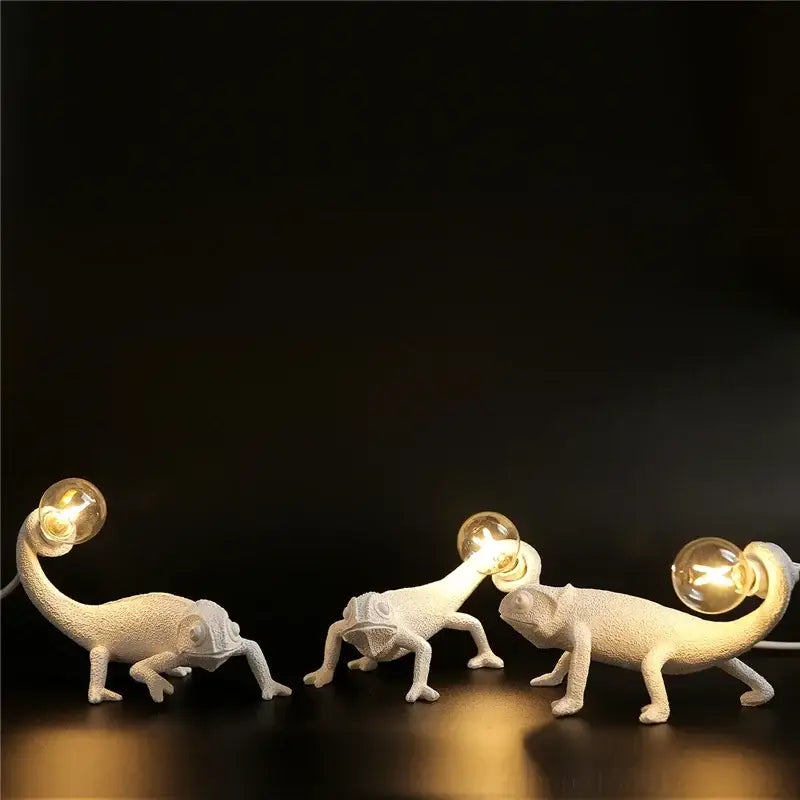 Three white modern resin decorbites chameleon led table lamps with textured bodies and exposed filament bulbs for reading
