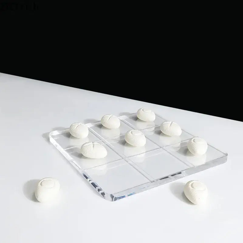 Modern clear acrylic tic-tac-toe set with white textured resin pieces for living room decor by decorbites acrylic