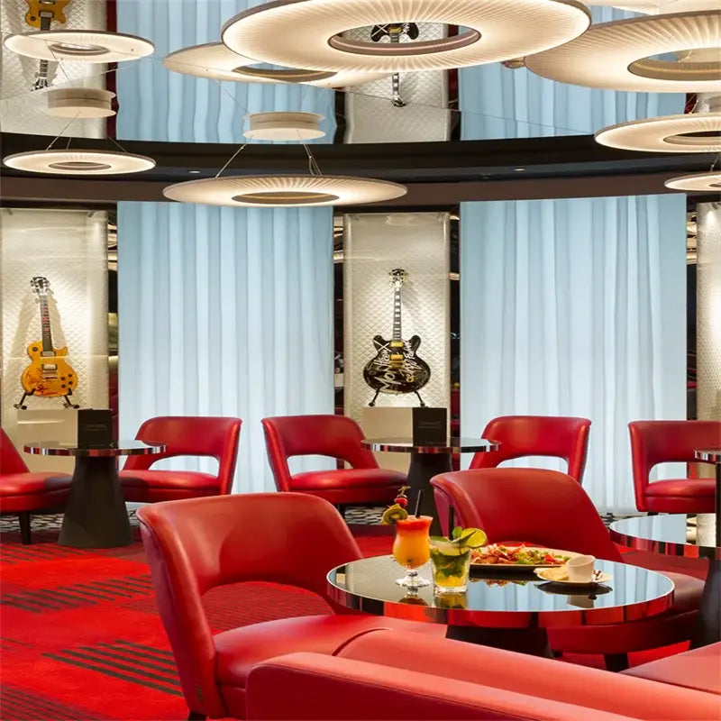 Modern white ribbed circular pendant light above red leather armchairs with curved backs and chrome tables decorbites hanging ceiling lamps