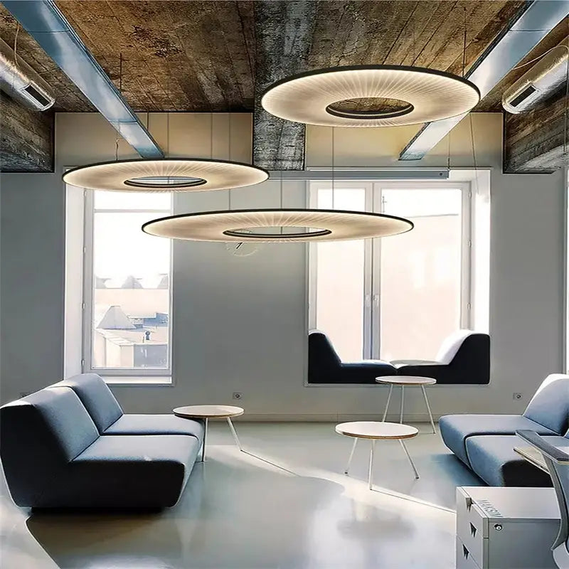 Three modern white ribbed circular pendant lights with warm glow and black frames for decorbites hanging ceiling lamps