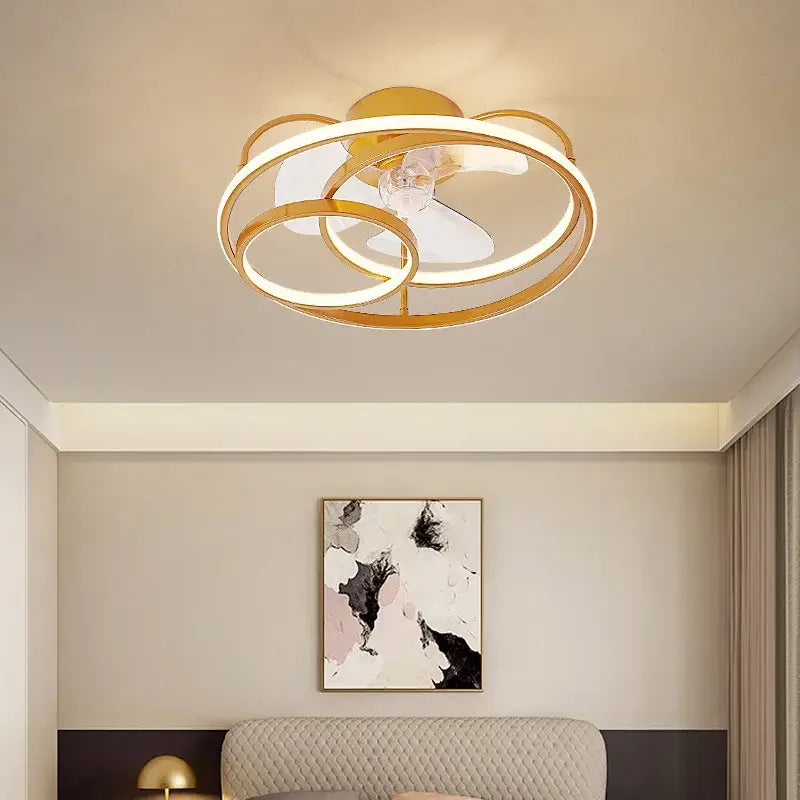 Modern white ring led ceiling fan with gold-toned circular frame, integrated led lighting, and clear glass accent for bedrooms