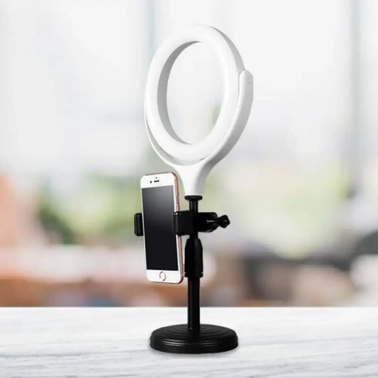 Modern white round mirror light with usb port and black stand holding smartphone in bedroom setup with round mirror light
