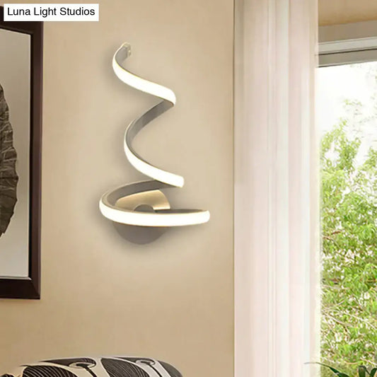 Modern white and silver spiral acrylic led wall sconce with sleek metallic finish and soft ambient bedroom lighting