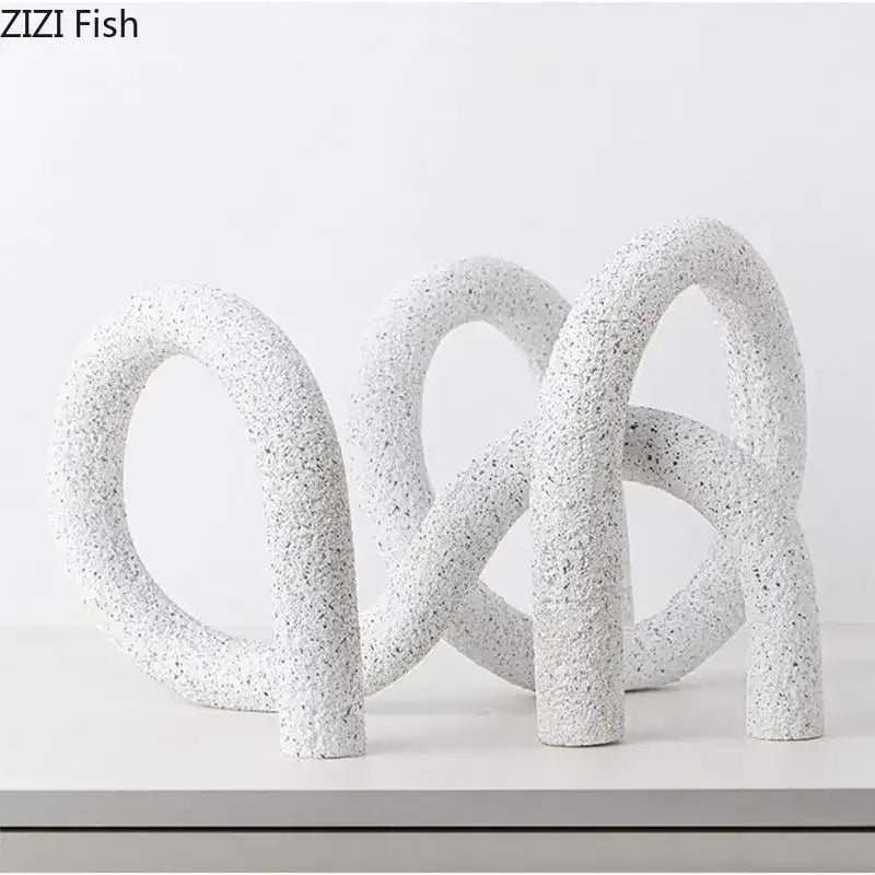Modern white speckled resin abstract twisted knot sculpture with interlocking looped forms for living room decor