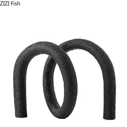 Black textured foam pool noodles shaped in an abstract twisted knot figure eight for modern living room decor