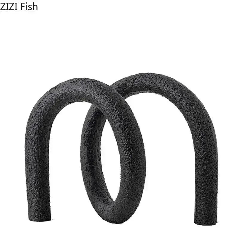 Black textured foam pool noodles shaped in an abstract twisted knot figure eight for modern living room decor