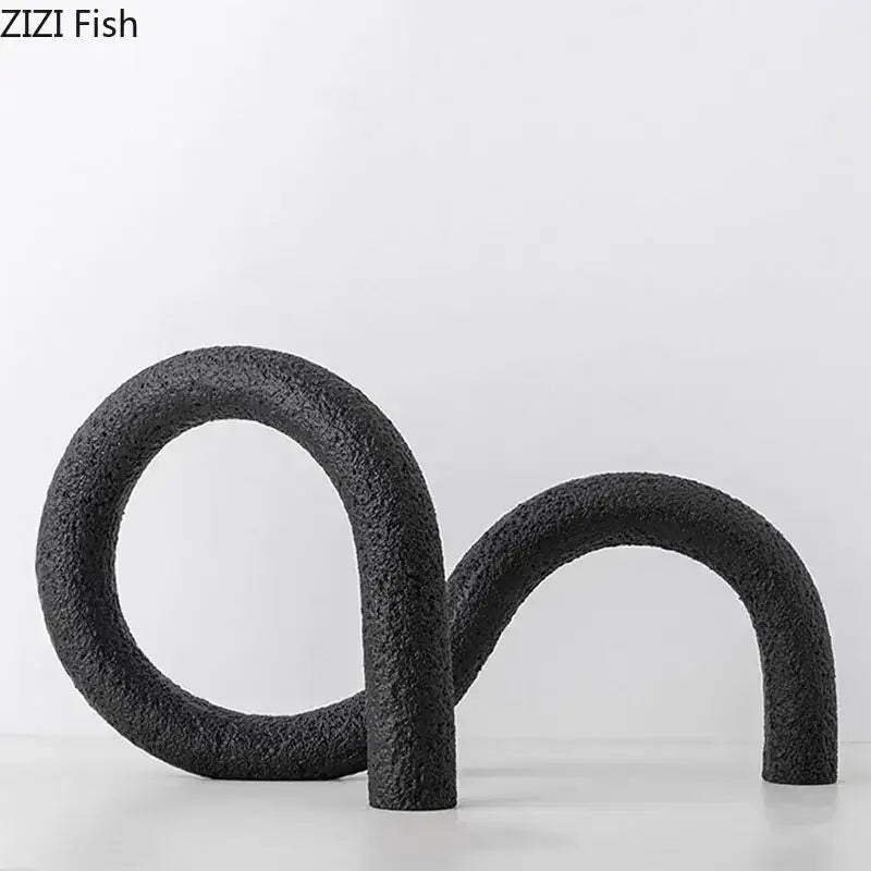 Black textured abstract twisted knot sculpture with two interlocking curved forms for modern living room decor