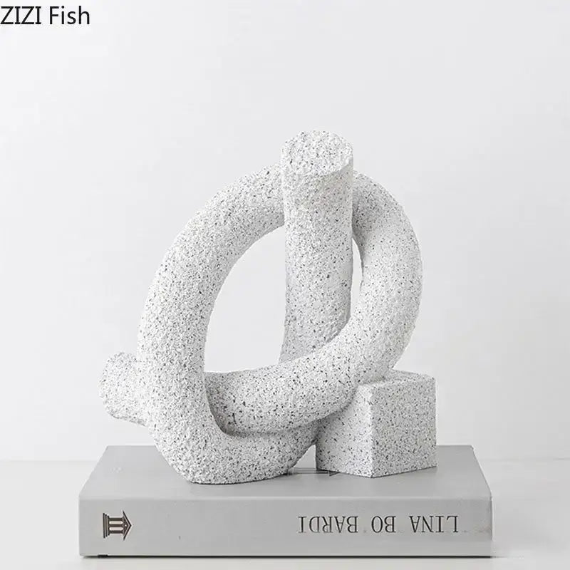 Modern white speckled abstract twisted knot sculpture in textured resin with interlocking rings and cube base for decor