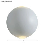 Modern white spherical wall light fixture with frosted glass and soft glowing interior for outdoor use