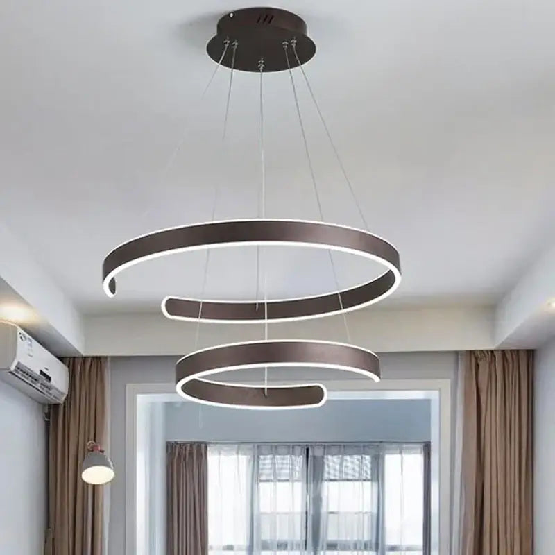 Modern bronze pendant light with three interlocking circle rings and glowing white led strips for dining room decorbites geometry circle
