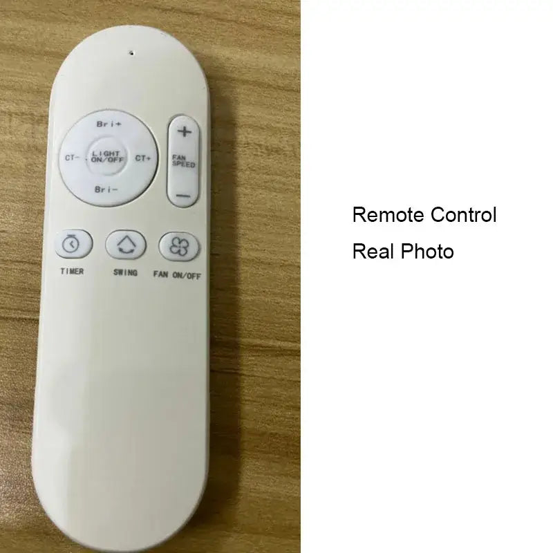 White plastic remote control with rounded edges for modern white square bladeless ceiling fan light in bedroom