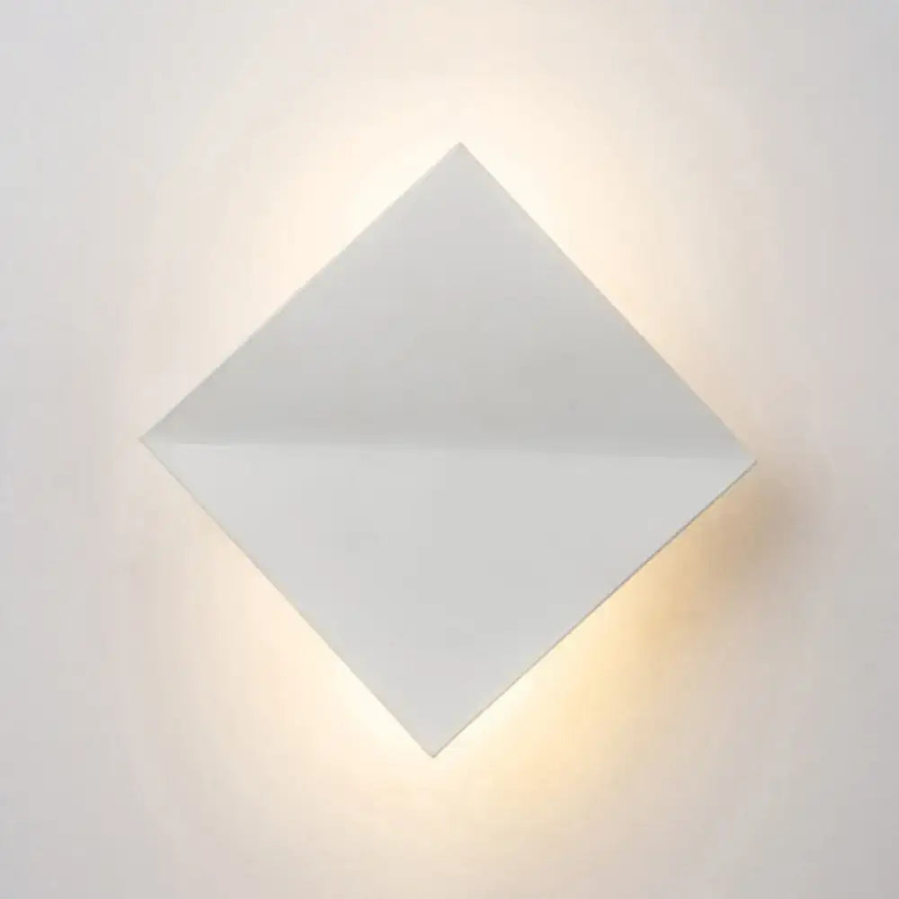 Modern white diamond wall sconce with direct wired electric installation emitting soft warm light for living space