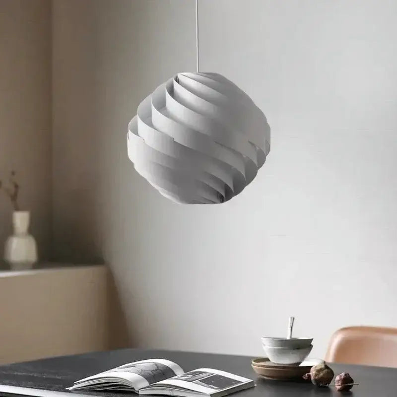 Modern white swirling spherical pendant light with layered ribbed design hanging from thin cord for dining room decorbites designer pendant lamp