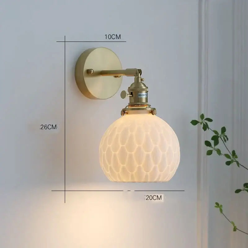 Vintage-style brass wall sconce with frosted honeycomb glass globe complementing decorbites ceramic led pendant lights