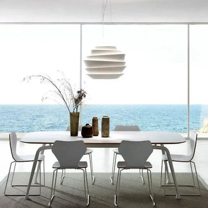 Modern white tiered industrial iron art pendant lights with sculptural design hanging above dining table decorbites industrial iron