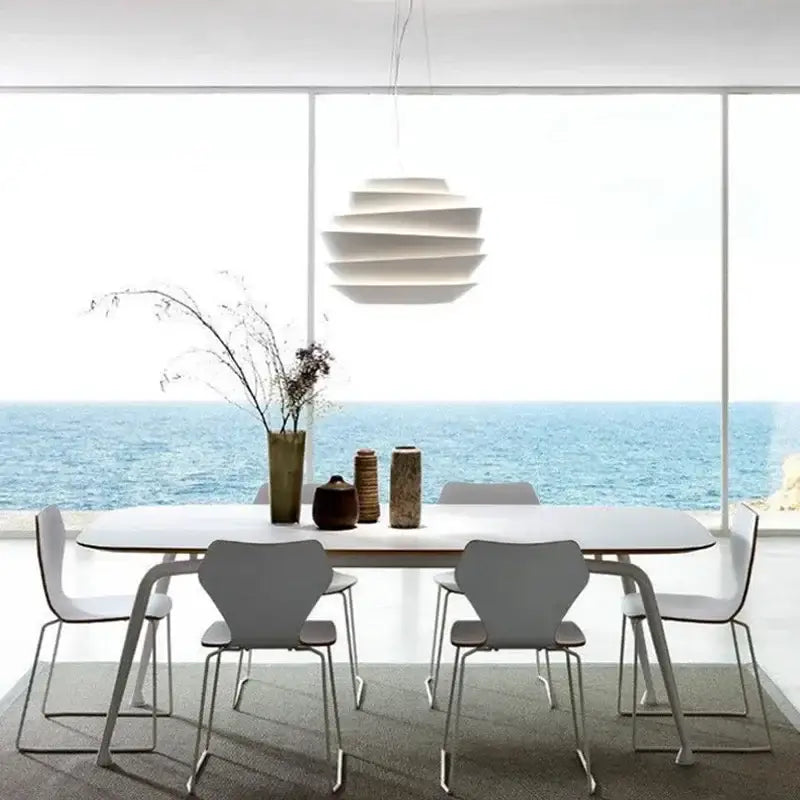 Modern white tiered industrial iron art pendant lights with sculptural design hanging above dining table decorbites industrial iron