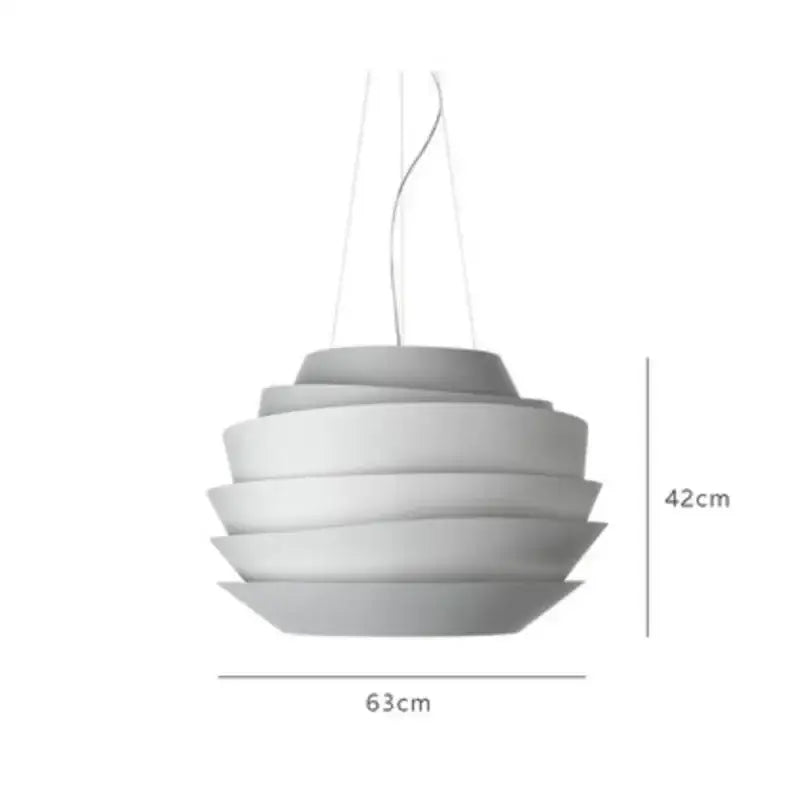 A modern, tiered pendant light with concentric circular rings in a matte white finish.