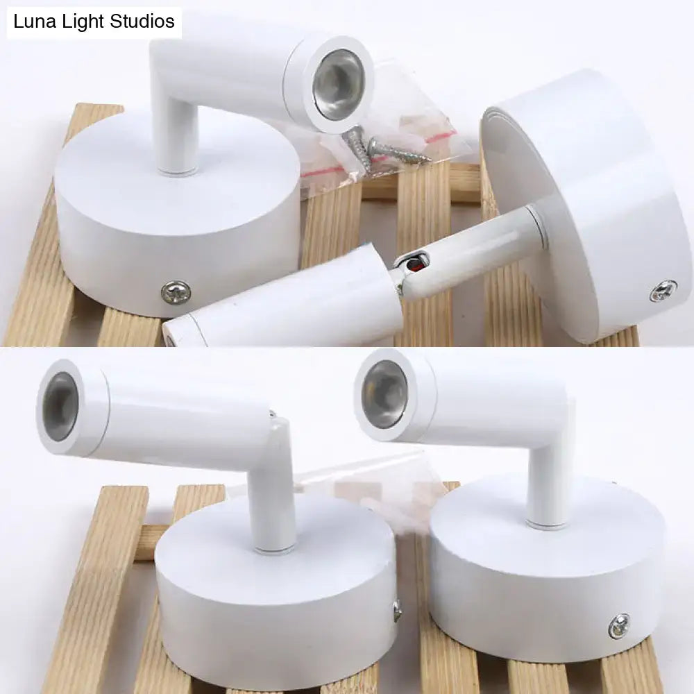Modern white tube wall light featuring adjustable arms and metallic bases ideal as a white light bedroom sconce