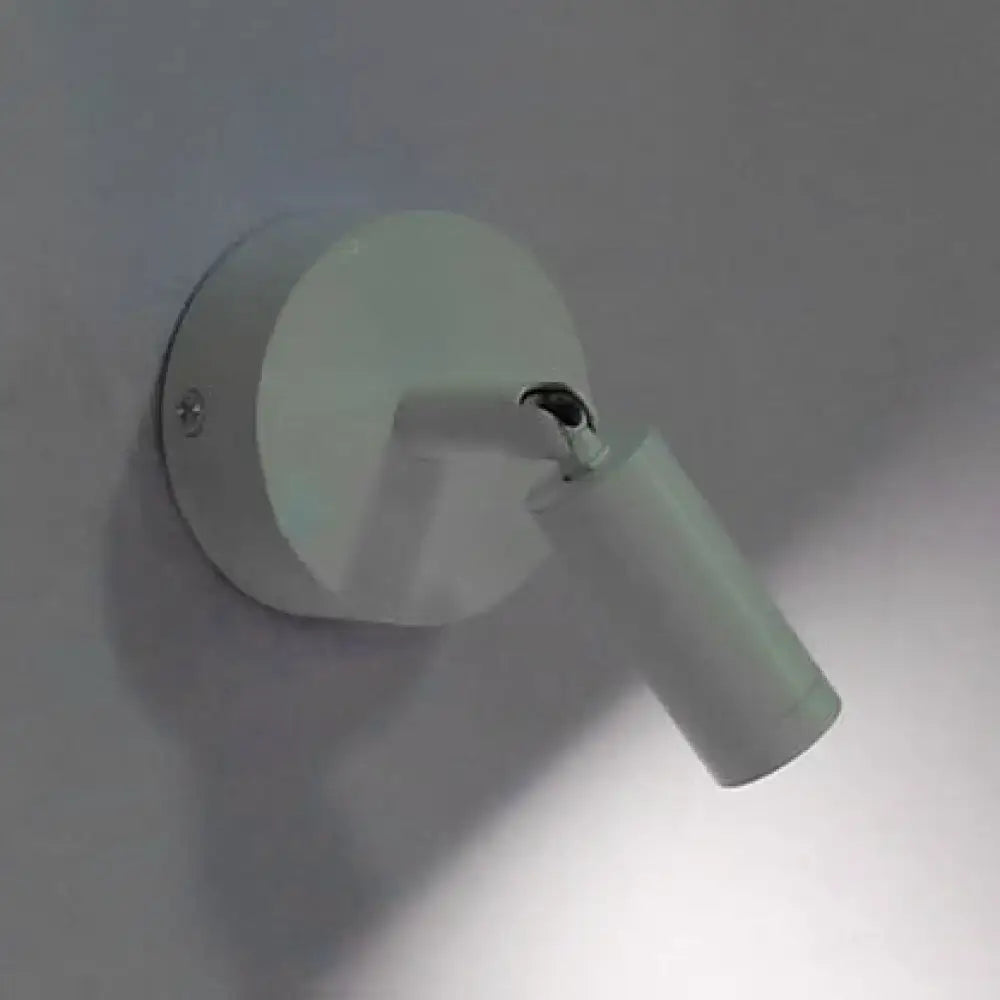 Modern white tube wall light with a sleek cylindrical head and adjustable arm for bedroom white light sconce use