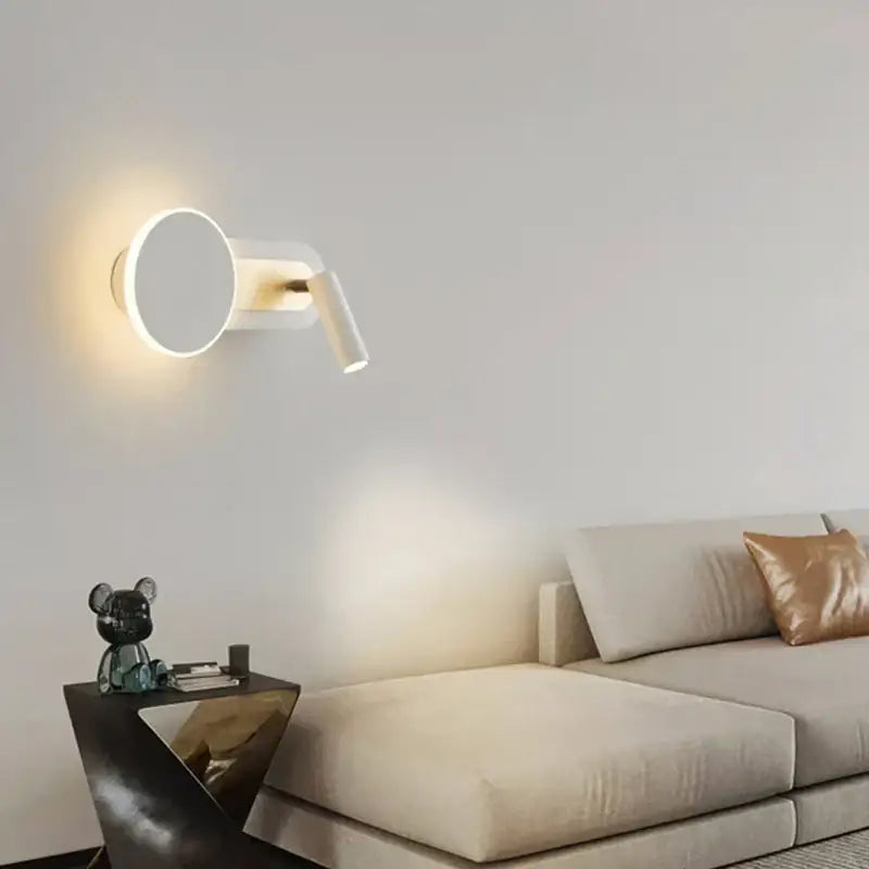 Modern white wall light with adjustable spotlight and circular base for living room decor featuring led wall light design