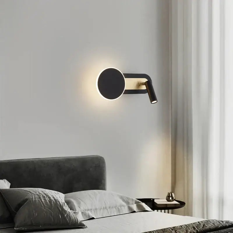 Modern black and gold led wall light with circular face and adjustable spotlight arm for living room decorbites led wall lighting