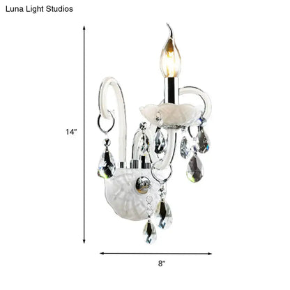 Elegant white wall sconce light with frosted glass base chrome accents and teardrop crystal decoration for living room