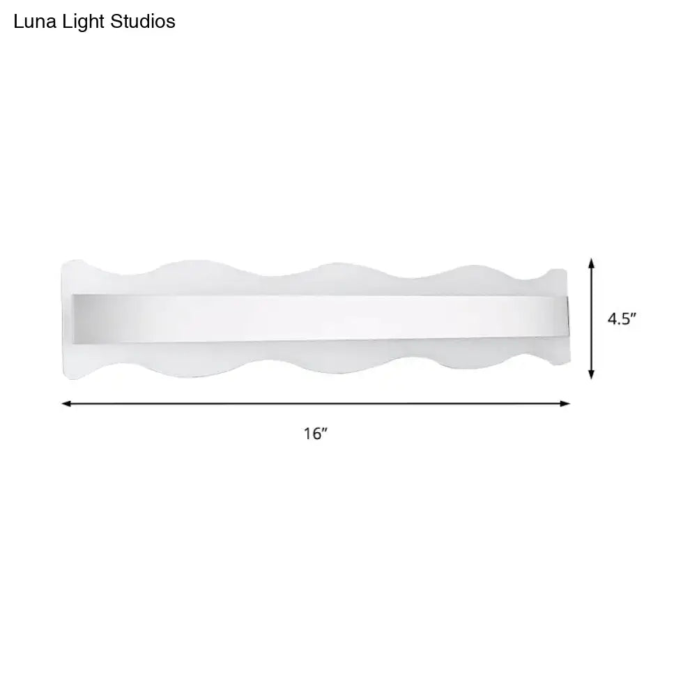 Modern white wave LED light fixture with a sleek wavy design and rectangular panel for warm bathroom lighting