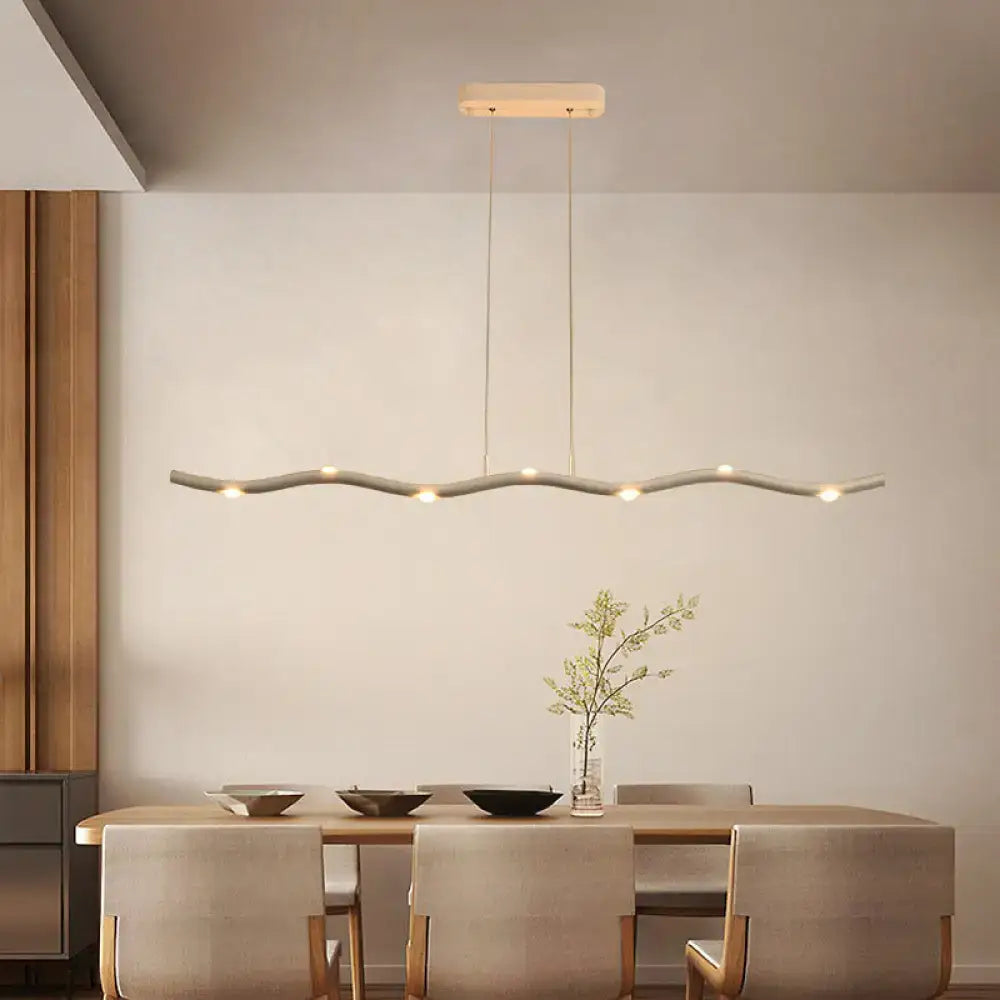 Modern white wave metal pendant light with a sleek gray body and warm LED lights for island lighting fixture