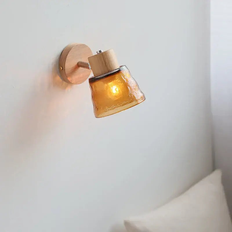 Modern wood and amber glass led wall sconce with warm amber hammered glass shade on light wood decorbites amber glass fixture