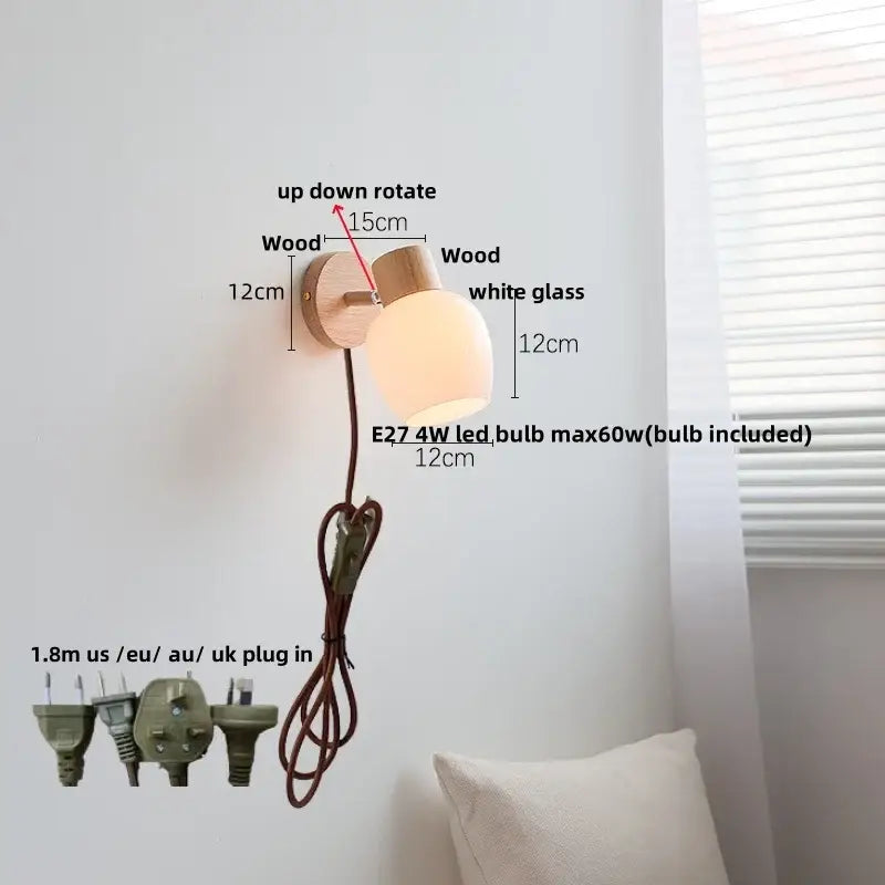 Modern wood and amber glass led wall sconce with a light wood base, frosted amber glass shade, and adjustable rotation