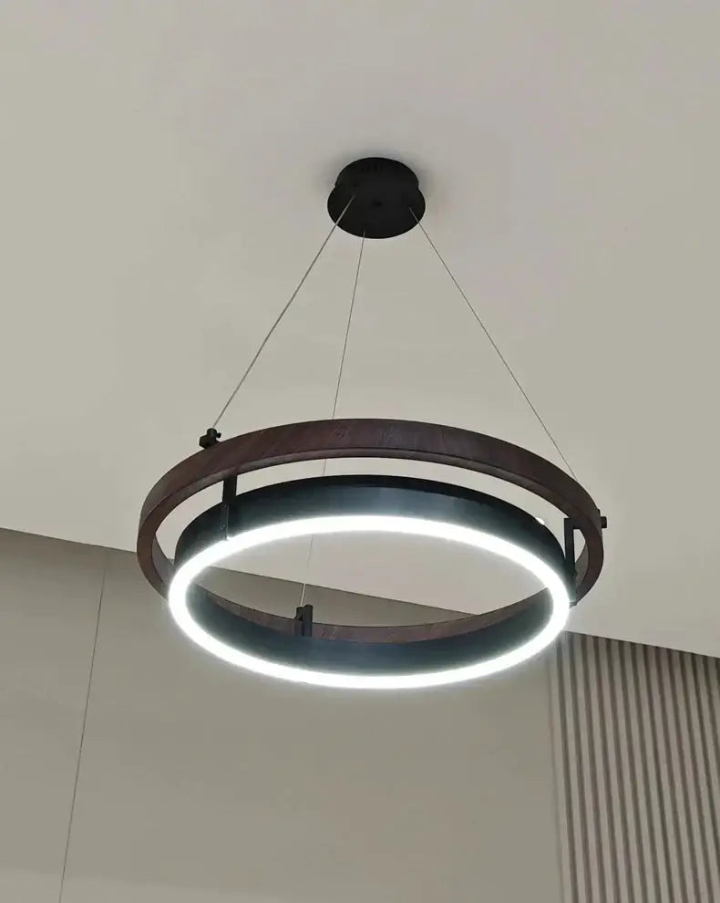 Modern wood and black double circular led chandelier featuring warm wood outer ring and sleek black frame for dining room