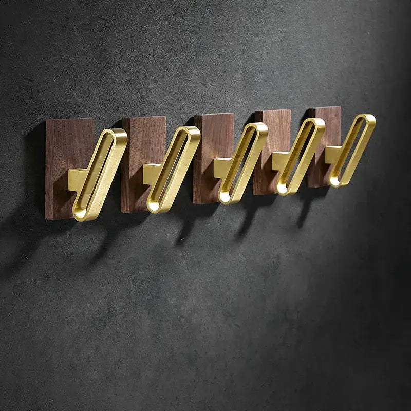 Set of five modern wall hooks with brushed gold metal loops and dark walnut wood backing plates for decorbites brass brushed decor