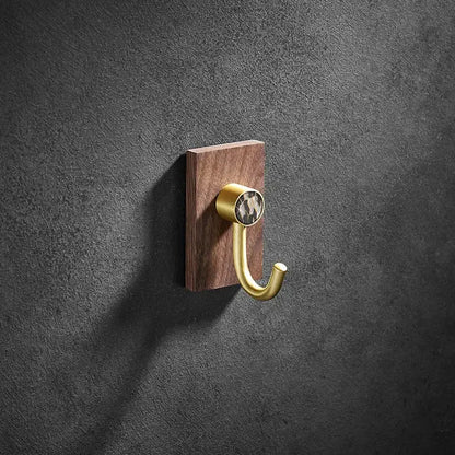 Modern wood and brushed gold wall hook with sleek brass brushed hook and patterned stone on dark wood plaque decorbites brass brushed