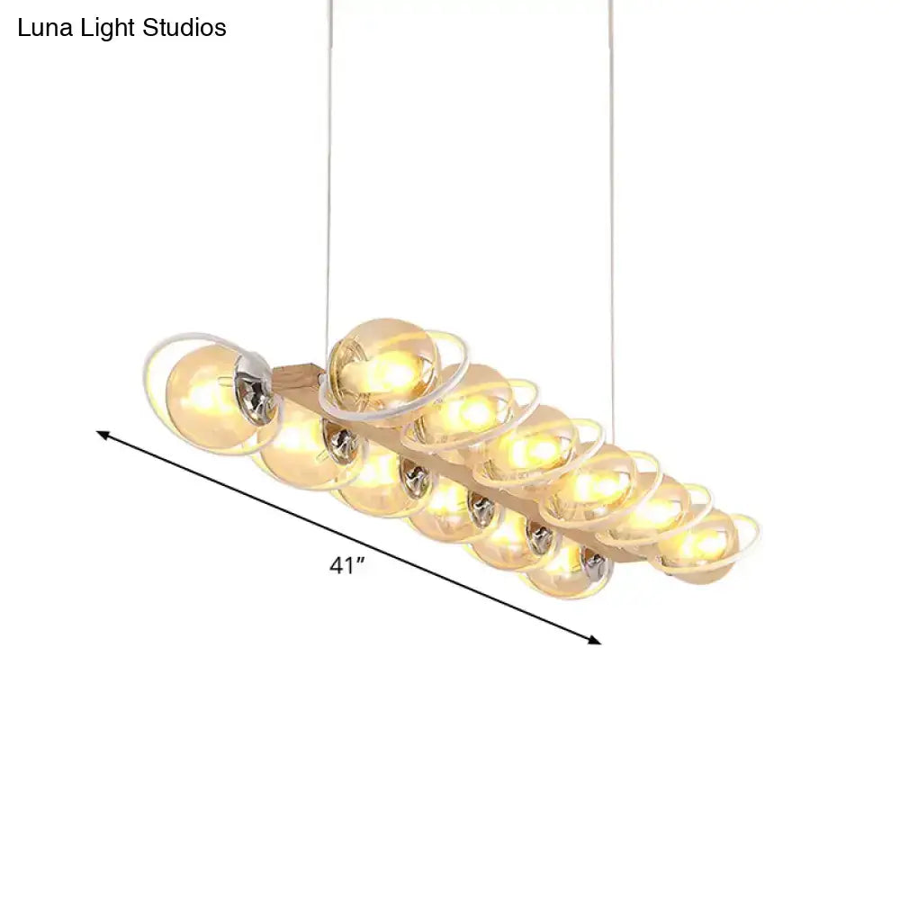 DecorBites™ modern glass hanging light fixture with a wooden base and cognac bubble shade island lighting design