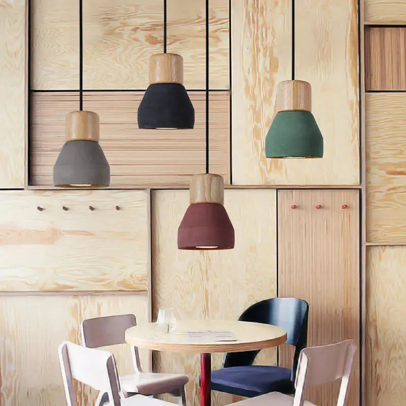 Modern wood and concrete pendant light featuring matte color-blocked ceramic shades in black gray green and terracotta decorbites concrete pendant
