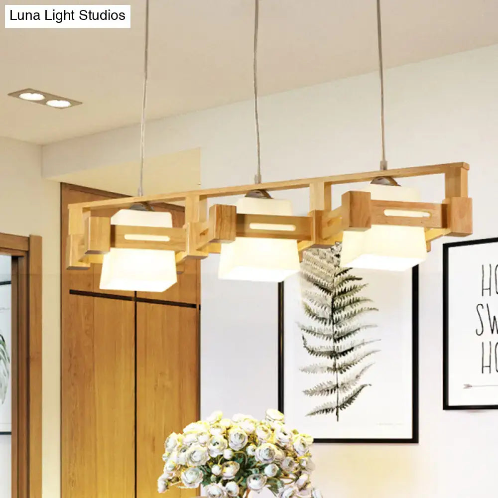 Decorbites modern cubic pendant lamp with wood cage, frosted glass island shades, and three beige bulbs