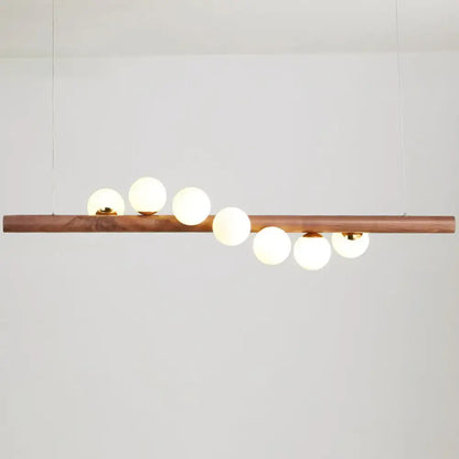 DecorBites minimalistic milk glass suspension light with warm wood bar and frosted globes for dining room lighting